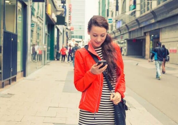 







Bigstock

Happy girl texting on the smart phone walking down the street wearing a red jacket in autumn